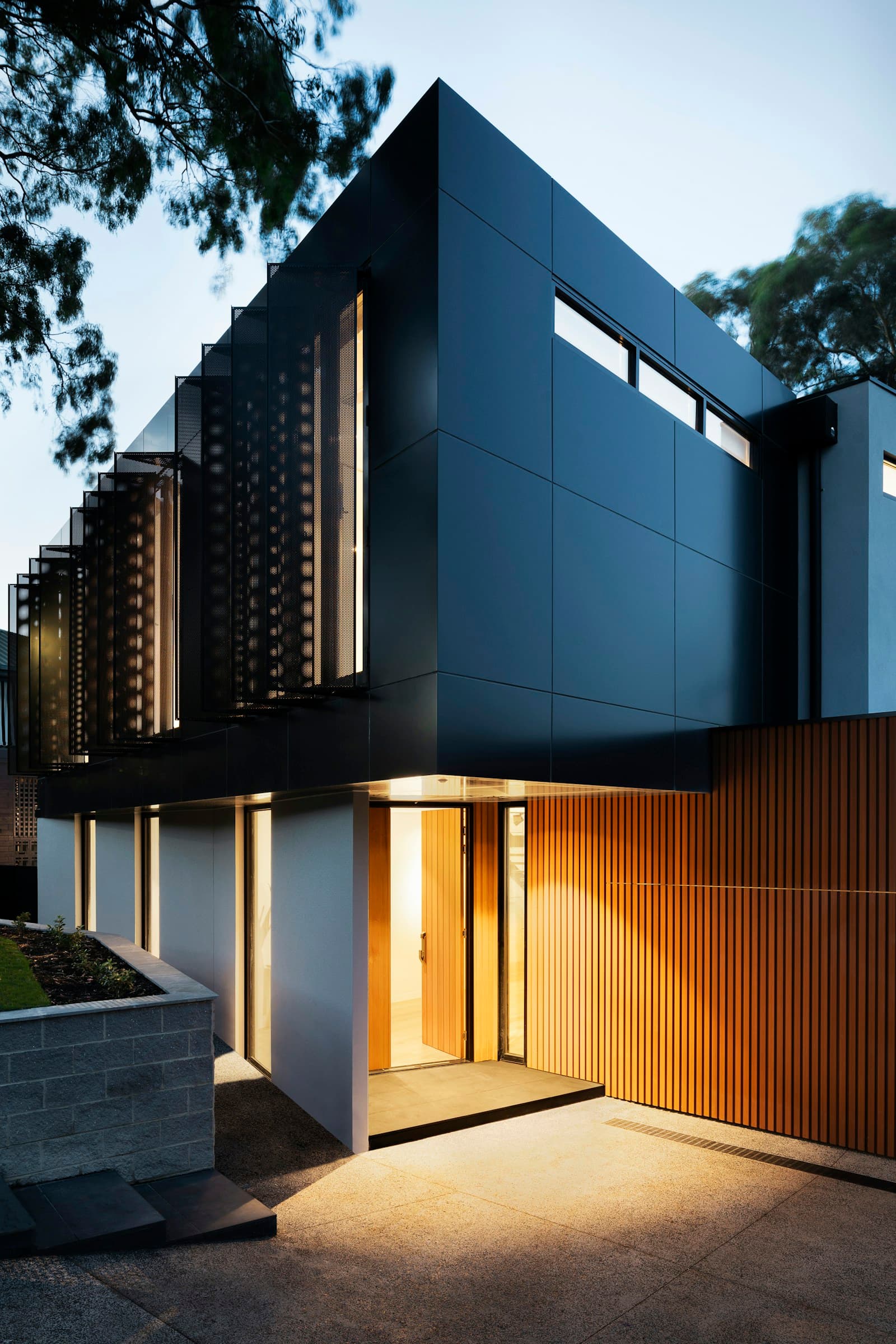 Contemporary home exterior with stone, timber and landscaping detail